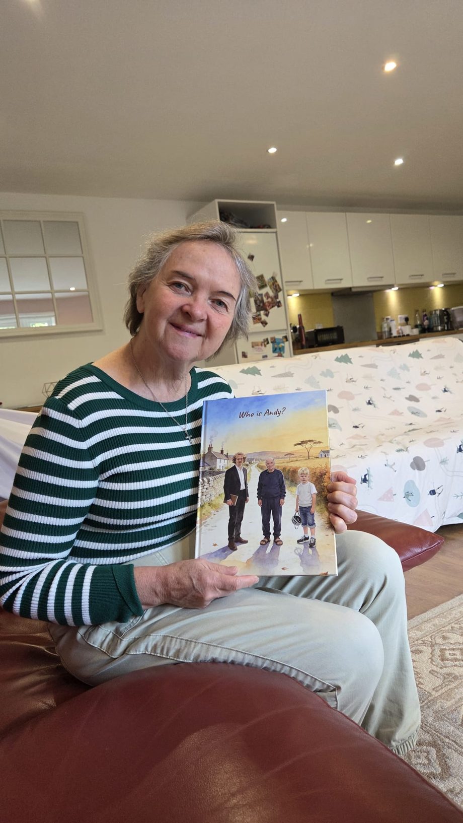 Ysy holding her finished personalised book, 'Who is Andy?', about her husband