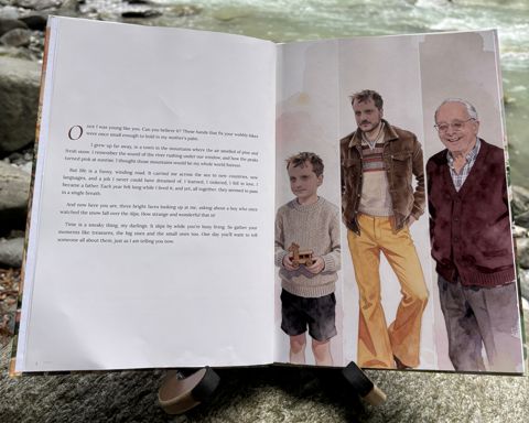 The printed book “Who is Opa?” by a river: Open at spread 2