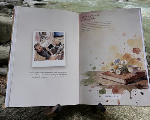 The printed book “Who is Opa?” by a river: Open at spread 11